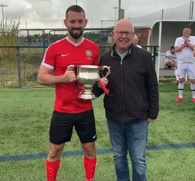 2025 Armagh & Down captain Phil Neill receiving McAleavey Cup from League Chairman Alan McClune