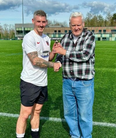 Nathan Riddle receiving his McAleavey Cup Man of the Match trophy from League Secretry Ivan Bell