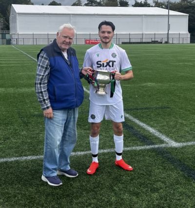 2026 McAleavey Cup being presented to Belfast South & East captain Ben Gordon by League Secretary
