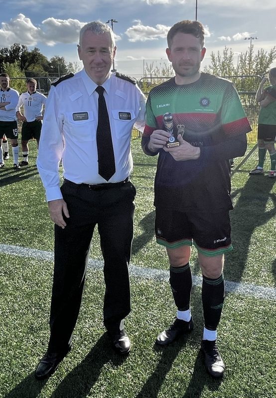 Chris Rice receiving his Man of the Match trophy from Chief Constable John Boucher
