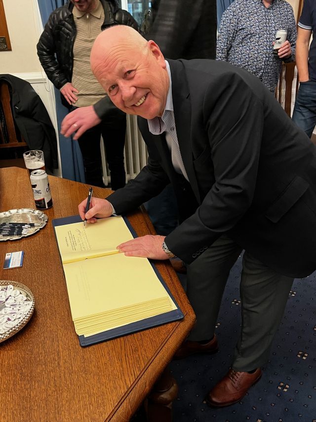 League chairman Alan McClune signing the visitors book at Douglas Couuncil headquarters