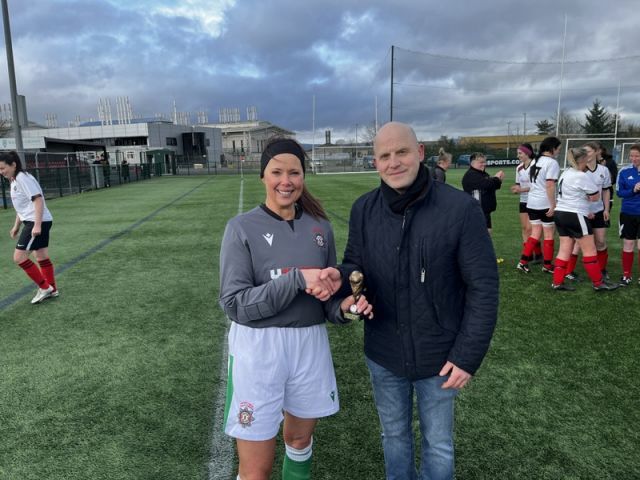 Player of the Match Caroline Ward (NIFS) receiving her trophy from PSNI League President Gary Busch