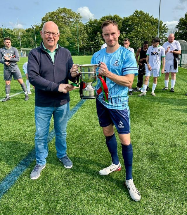 OSD's Mark Anderson receiving the McDowell Cup 2024 from League Chairman Alan McClune