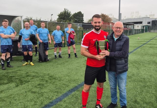 Phil Neill receiving the 2024 Buckley Cup for Armagh & Down from Legue Chairman Alan McClune