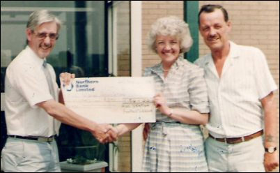 presenting a cheque to Jean Saunderson on behalf of the RUC Widows Association